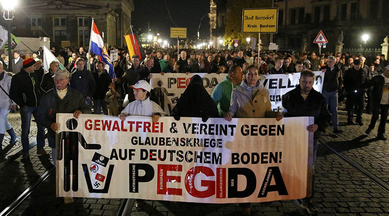 Supporters of the anti-immigration rightwing movement PEGIDA (Patriotic Europeans Against the Islamisation of the West) march during their weekly gathering in the historic part of Dresden, Germany October 26, 2015. REUTERS/Fabrizio Bensch